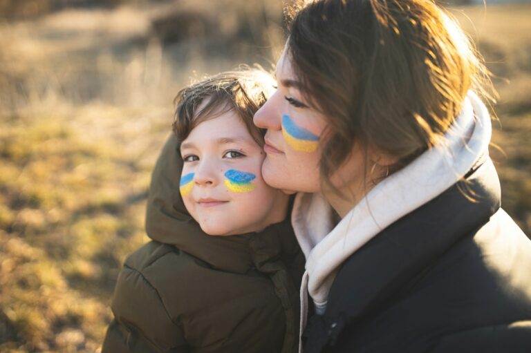 Ukrainian mother with her son. Patriots of Ukraine. Refugees from Ukraine. War against Ukraine.